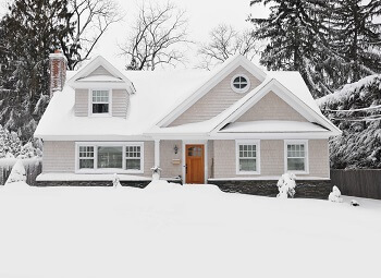 Single family home covered in snow